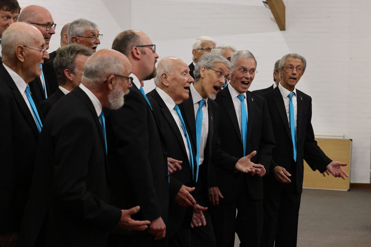 Photo shows the Fine City Chorus guys in full flow at the dress rehearsal